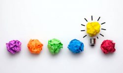 Great idea concept with crumpled colorful paper and light bulb on white background